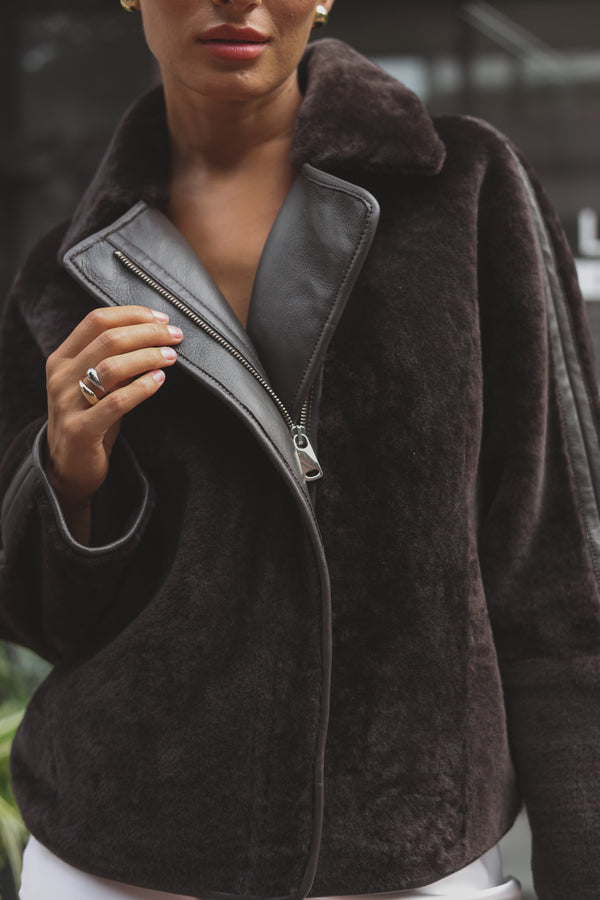 Premium brown merino sheepskin jacket showcasing luxurious texture and elegant design.